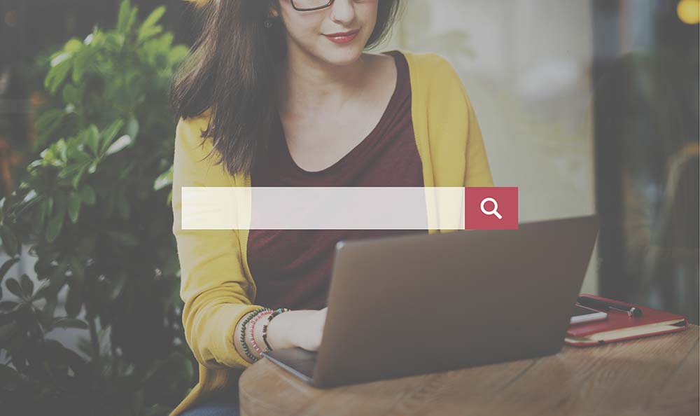 Young woman using a search engine on her laptop