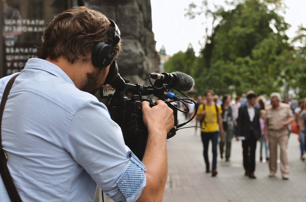 Cinematographer shooting a video for his clients business